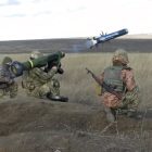 In this image taken from footage provided by the Ukrainian Defense Ministry Press Service, a Ukrainian soldiers use a launcher with US Javelin missiles during military exercises in Donetsk region, Ukraine, Wednesday, Jan. 12, 2022. President Joe Biden has warned Russia's Vladimir Putin that the U.S. could impose new sanctions against Russia if it takes further military action against Ukraine. (Ukrainian Defense Ministry Press Service via AP)