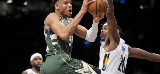Milwaukee Bucks forward Giannis Antetokounmpo (34) looks to pass on a drive against Brooklyn Nets center Day'Ron Sharpe (20) during the second half of an NBA basketball game, Tuesday, Feb. 28, 2023, in New York. (AP Photo/John Minchillo)