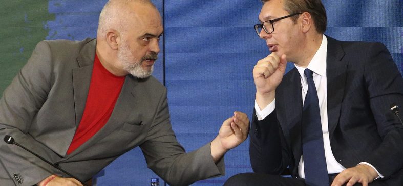 Albania's Prime Minister Edi Rama, left, talks to Serbia's President Aleksandar Vucic, right, during the economic forum for regional cooperation in Skopje, North Macedonia, Thursday, July 29, 2021. Frustrated with infinite delays in a process to join the European Union, three Balkan leaders have agreed on Thursday their countries to open borders in 2023 to secure free movement of people and goods without administrative procedures. (AP Photo/Boris Grdanoski)